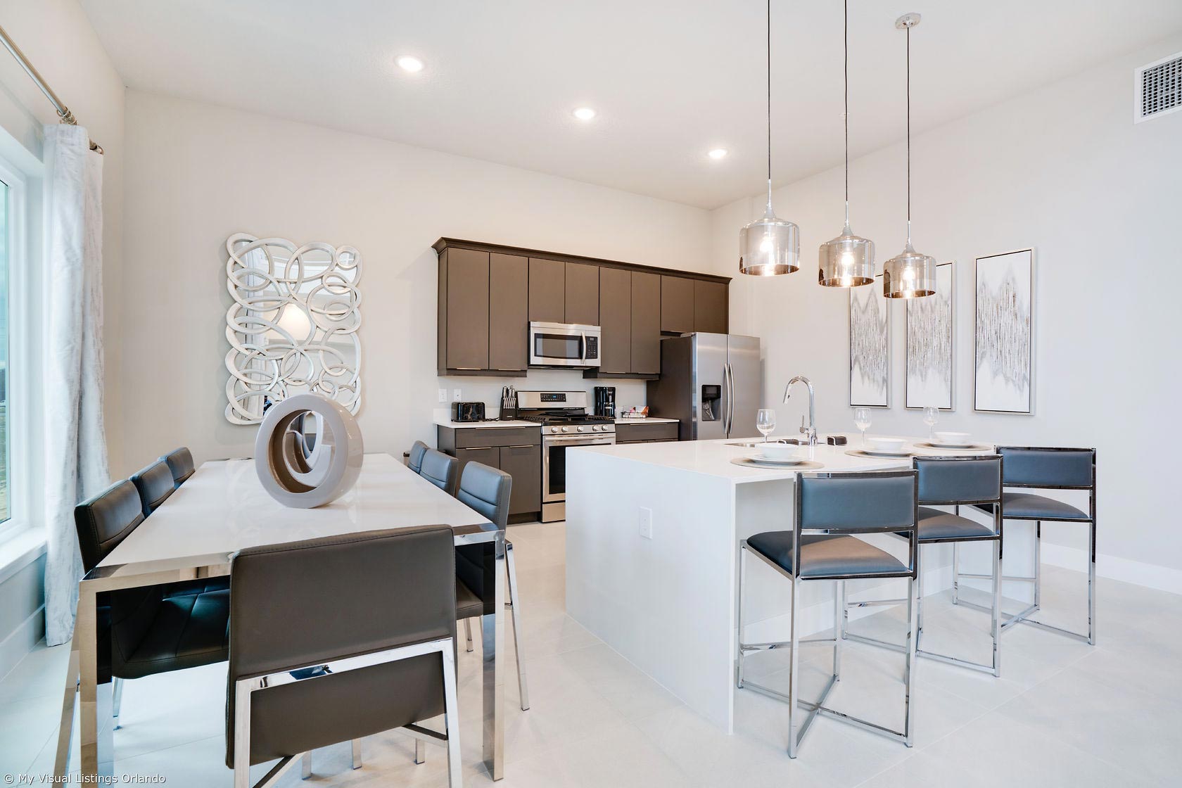 media-spectrum-resort_home-model-b-6 Furnished kitchen and dining room.