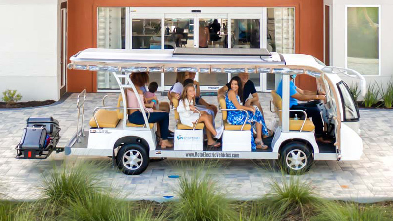 Family Arriving At The Spectrum Resort Orlando Clubhouse On A Golf Cart.