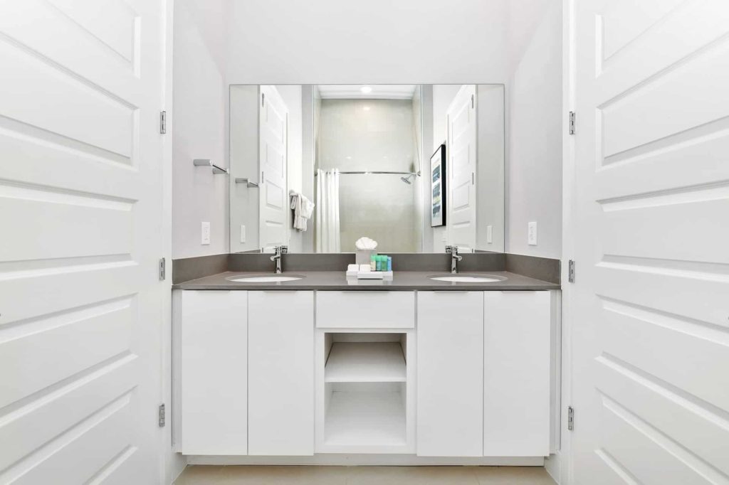 Bathroom 2 with double sinks and cabinets: 4 Bedroom Condo