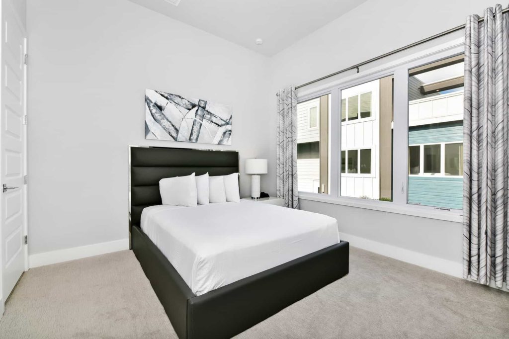Bedroom 2 with queen bed and large windows: 4 Bedroom Condo