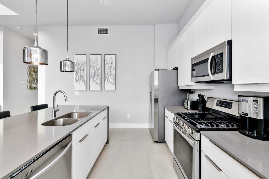 Full kitchen with island, oven range, and refrigerator: 4 Bedroom Condo