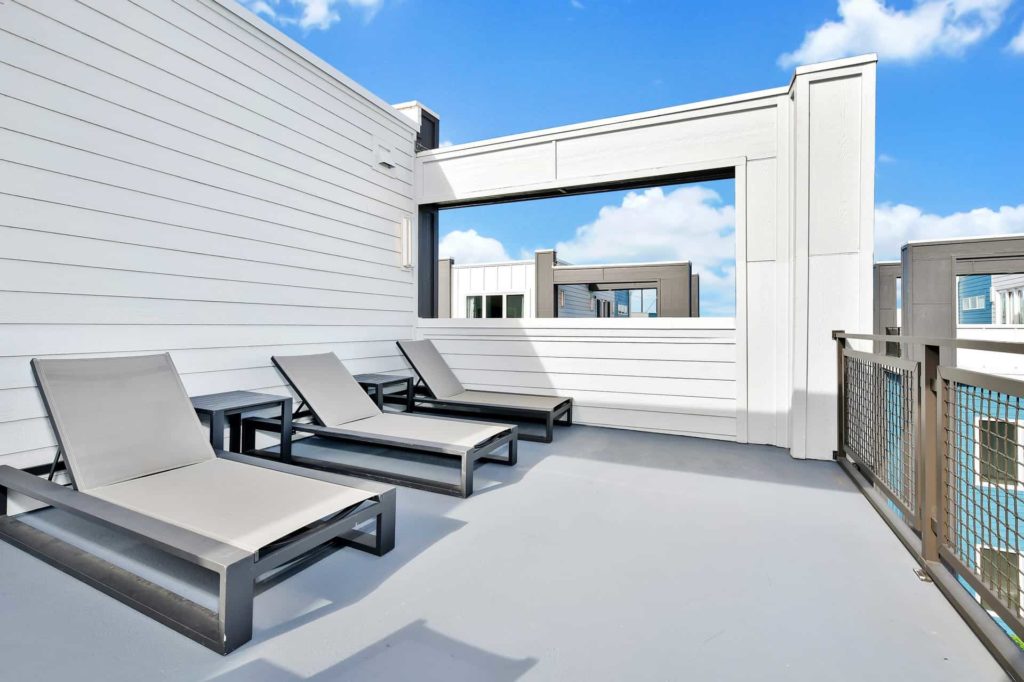 Sun loungers on outdoor upper-floor patio: 4 Bedroom Condo