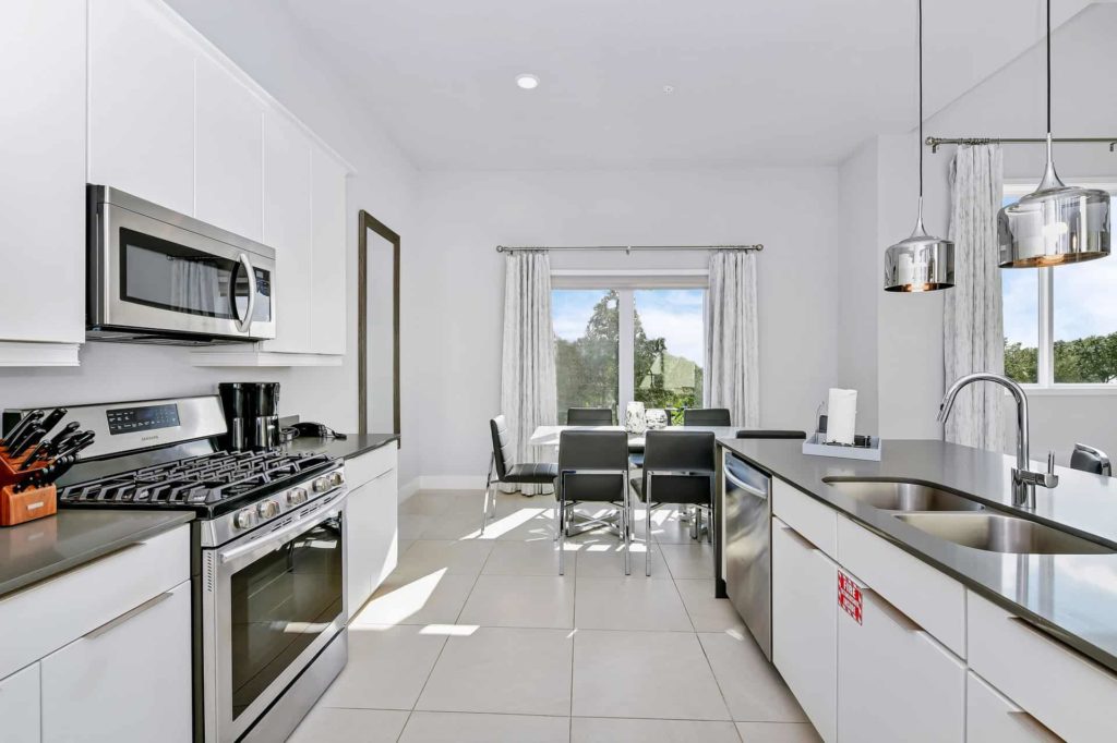 Fully equipped kitchen with oven range and large island sink: 5 Bedroom Condo