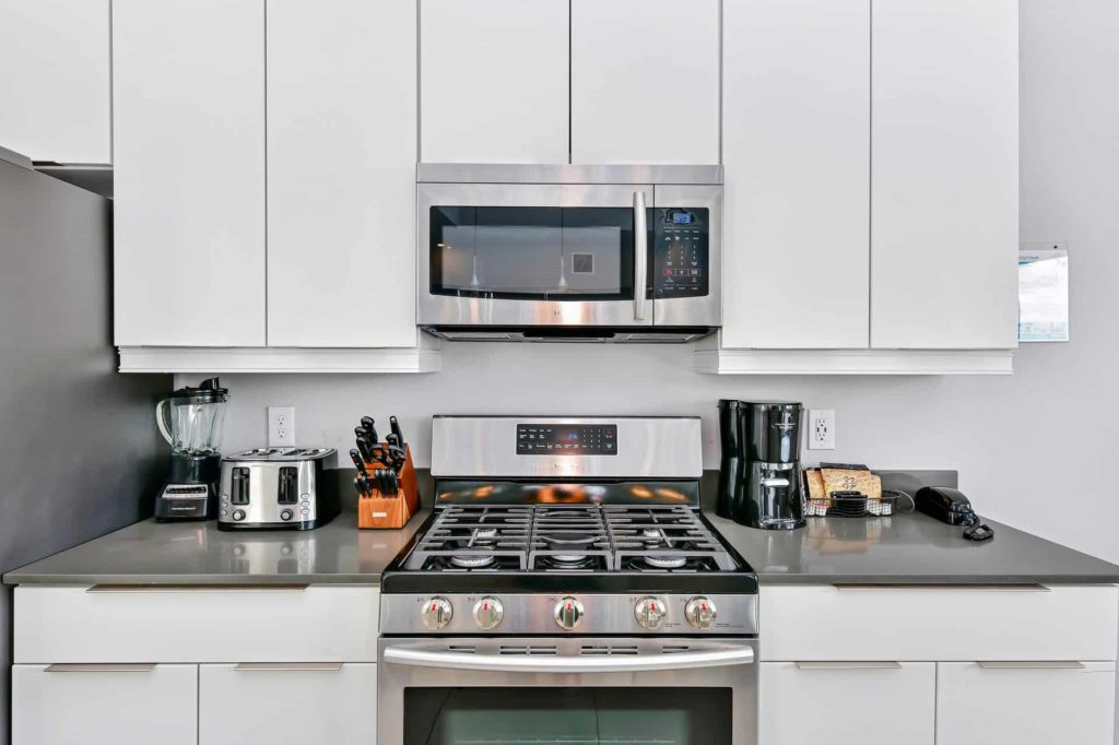 Full kitchen with oven range and over-range microwave: 5 Bedroom Condo