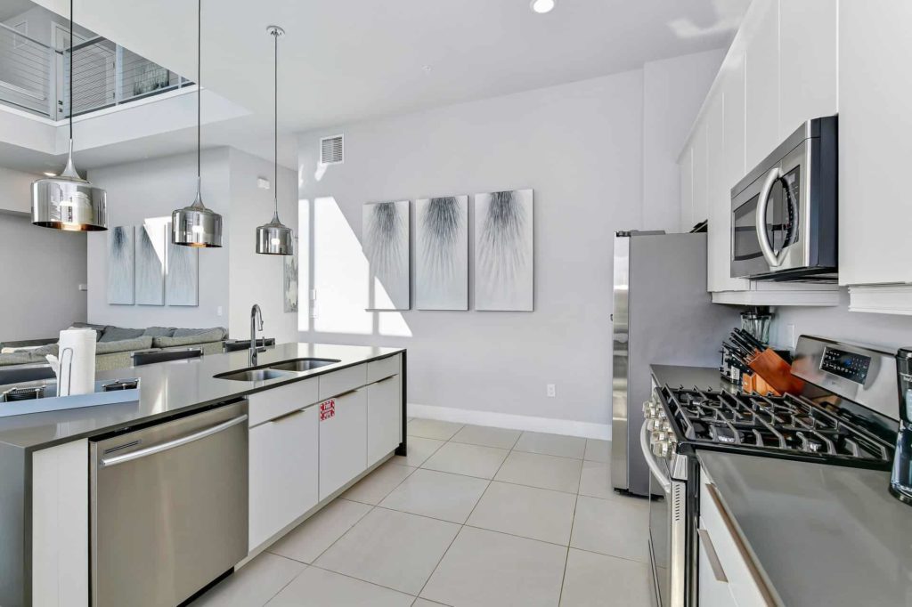 Full kitchen with oven range, island sink, and dishwasher: 5 Bedroom Condo