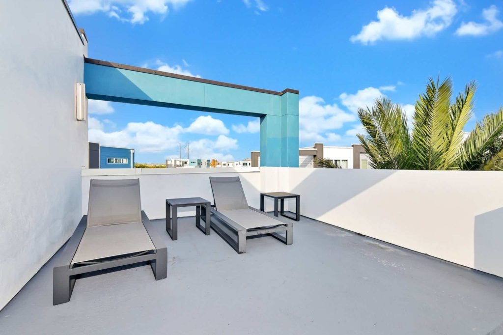 Outdoor terrace with sun loungers and view of property: 5 Bedroom Condo