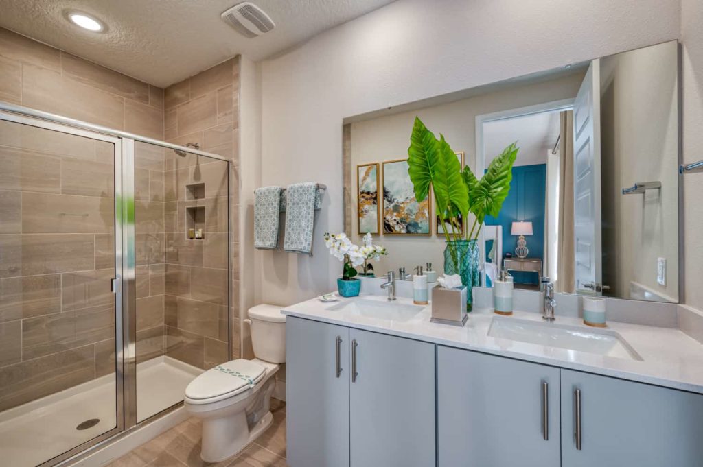 Bathroom 1 with double sinks, toilet, and walk-in shower: 3 Bedroom Townhome