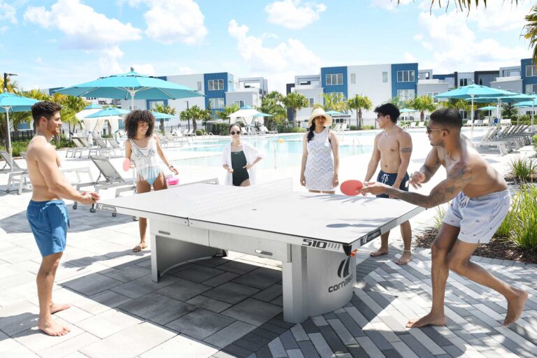 Group of friends playing a game of ping pong at Spectrum Resort Orlando