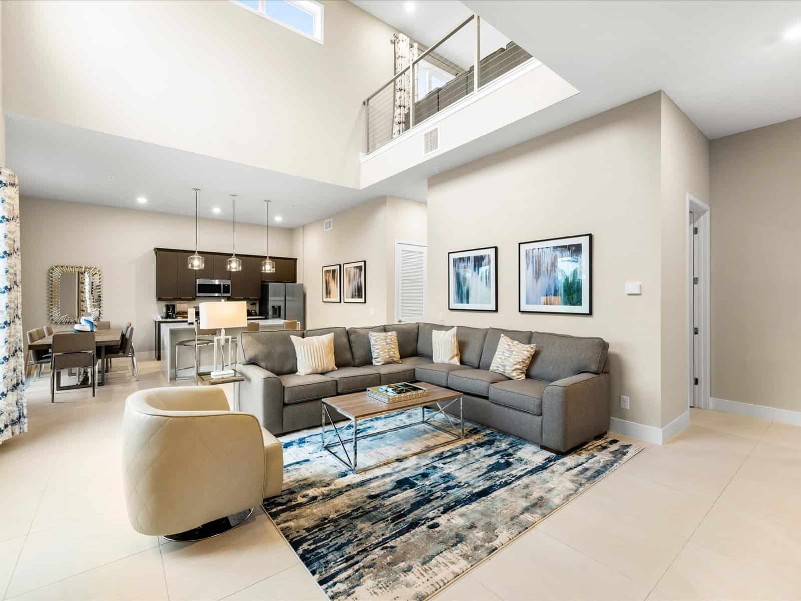 Living area with sofa, armchair, coffee table, and overhanging loft