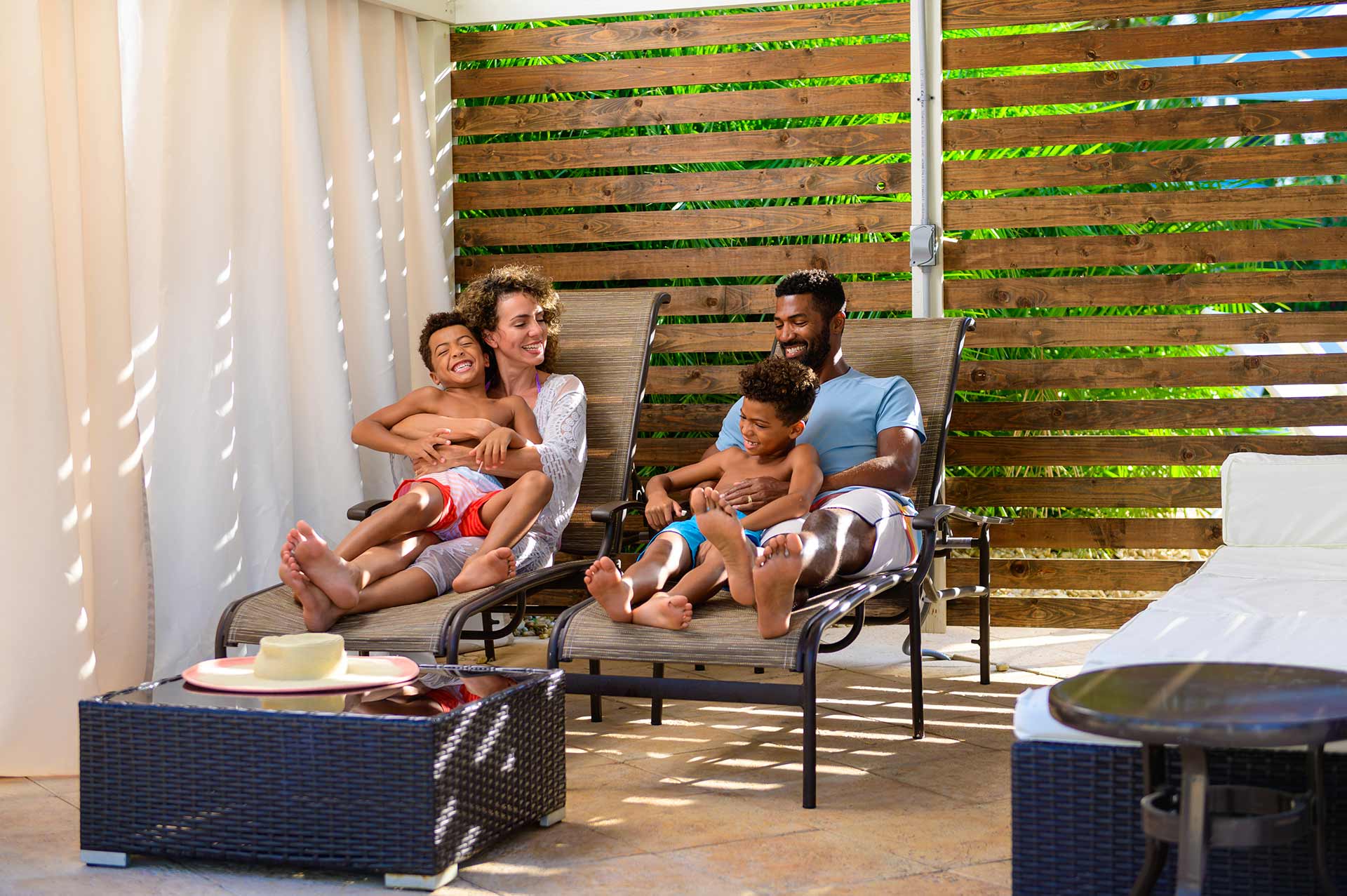 Family relaxing in in their private cabana at the Reunion Resort Water Park