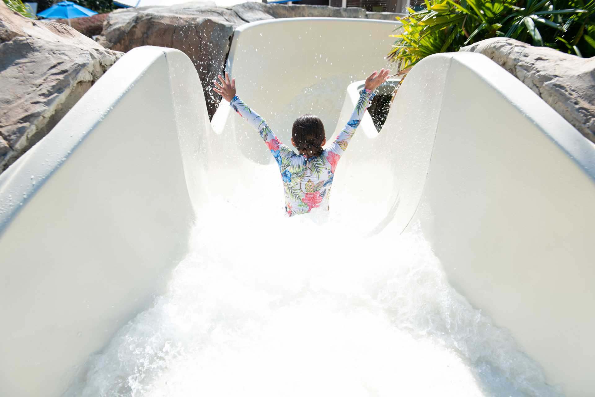 Young girl going down the water slide at the Reunion Resort Water Park