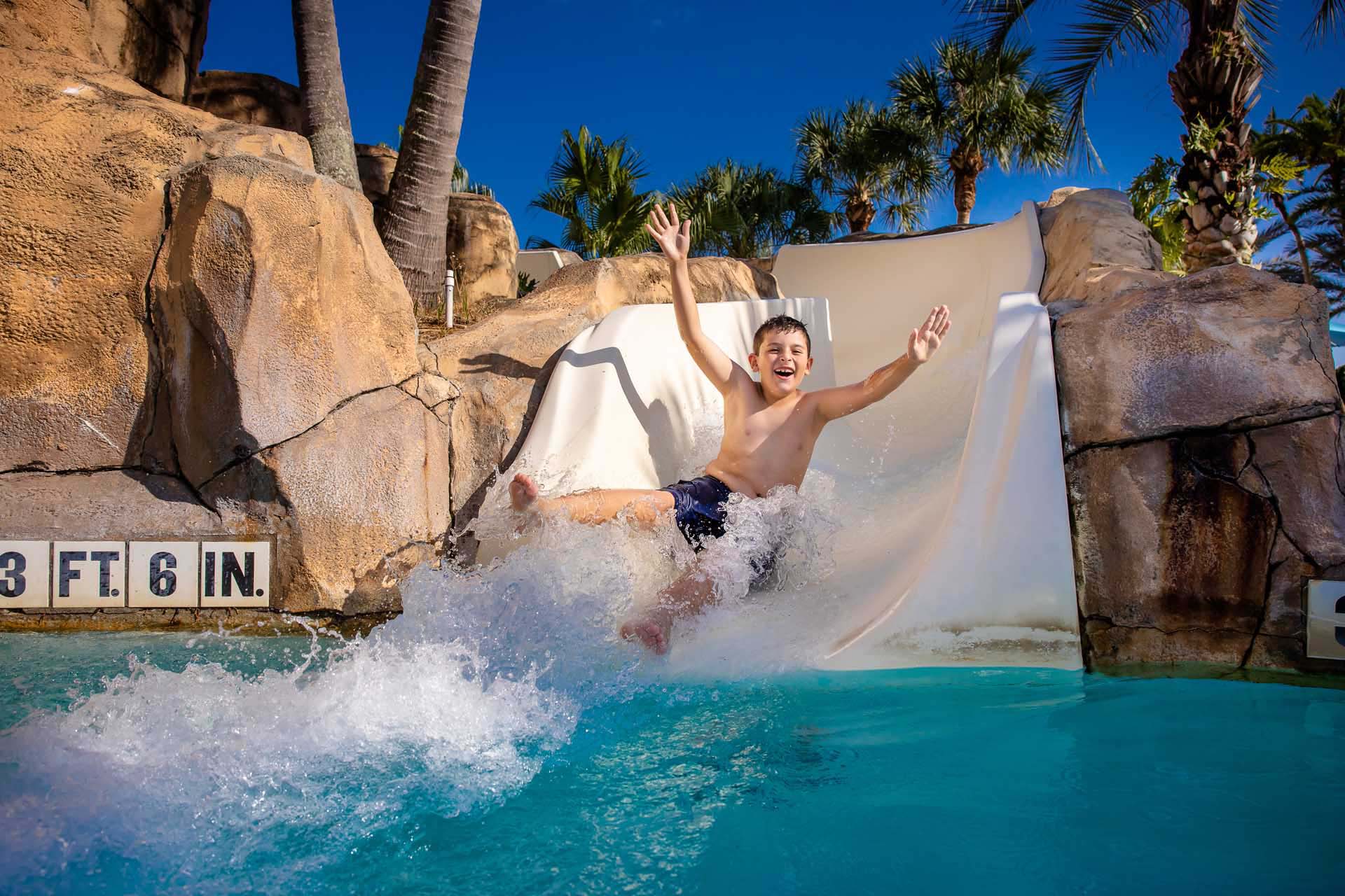 Young boy going down the water slide at the Reunion Resort Water Park