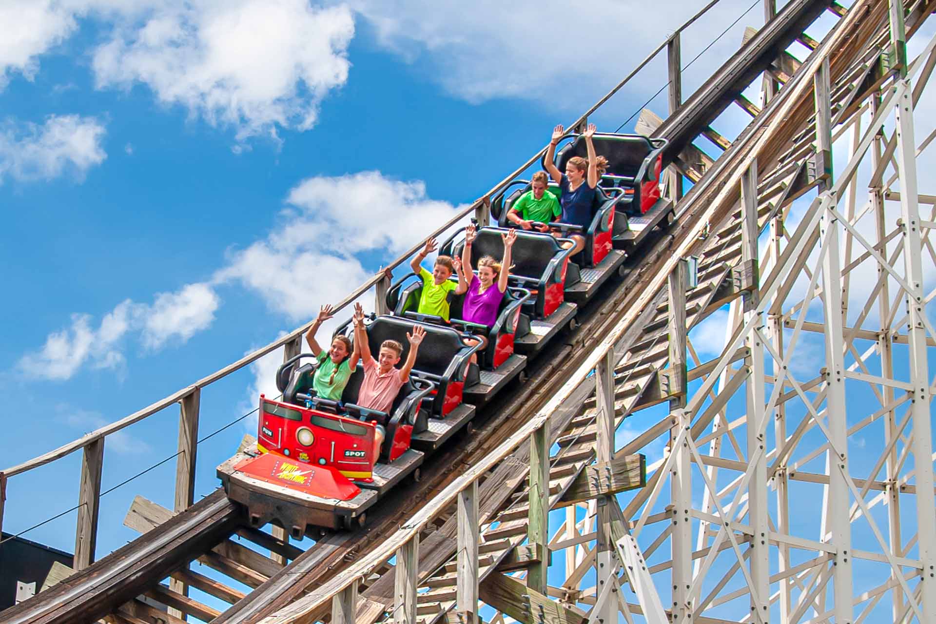 Group riding the White Lightning wooden roller coaster at Fun Spot America in Orlando