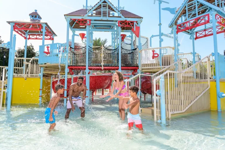 Happy family having fun and splashing in the Reunion Resort Water Park