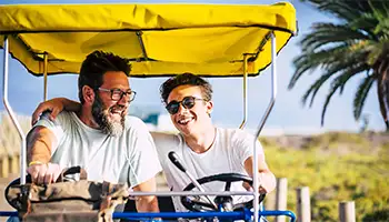 Activities: Father and son riding a surrey bike together.