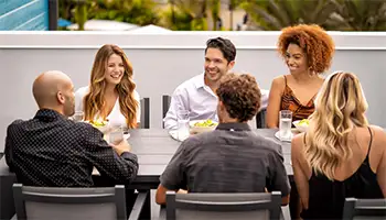 Dining: Group dining together on the upper floor outdoor balcony of a Spectrum Resort Orlando condo